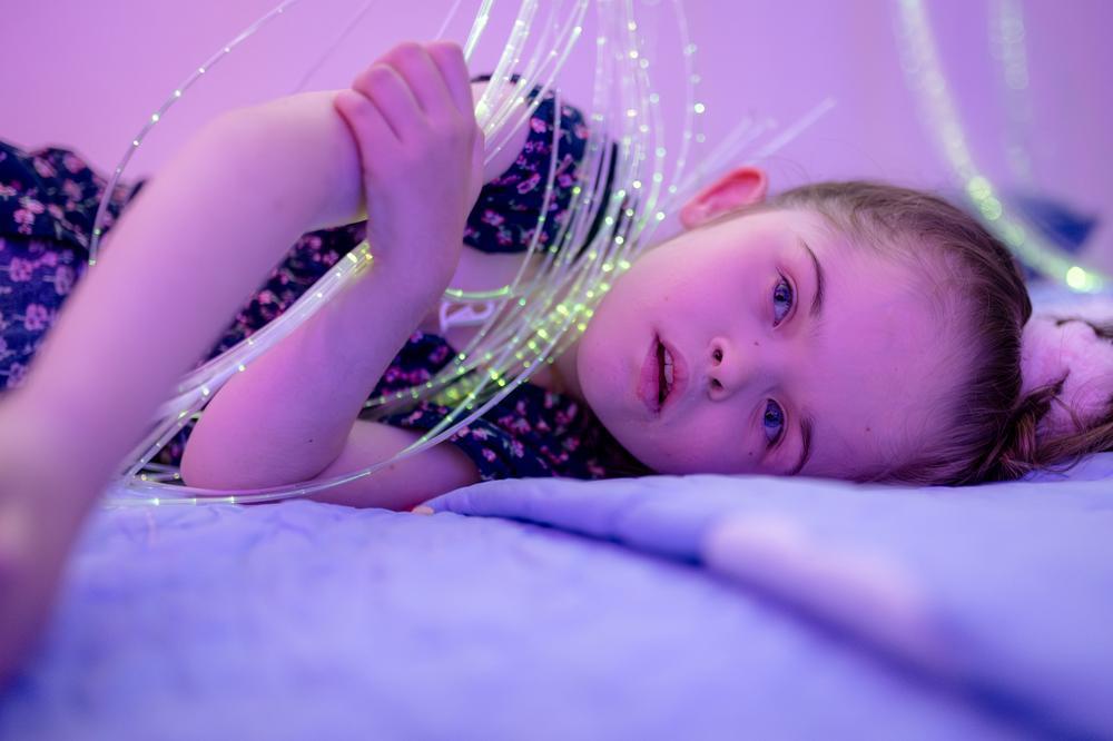 Girl lying on her side in the sensory room